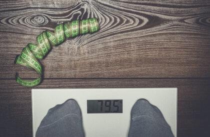 grey electronic scales on the wooden floor dieting concept