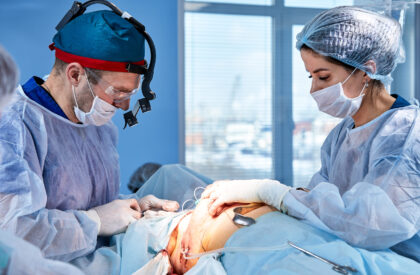 The doctor performs an operation to reconstruct the female breast. Close-up of plastic surgeon performing implantation procedure, breast cancer.