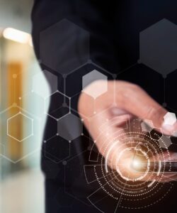 Businessman holding smartphone with technology icons with blurred background.